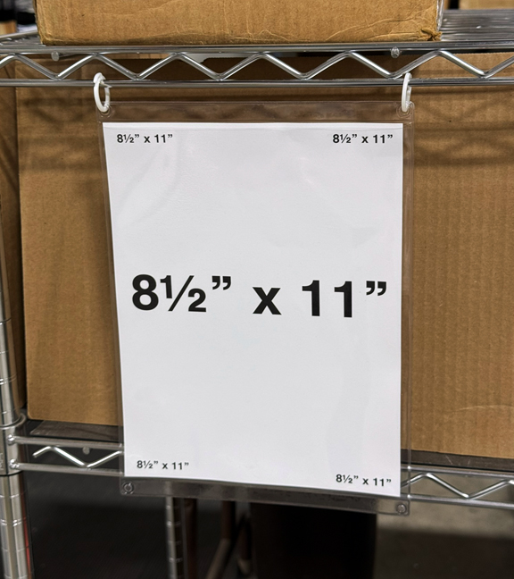 Grommet-style holder on wire rack for warehouse