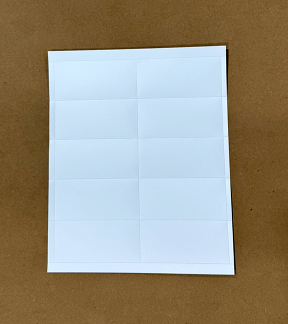 Durable, laser printable plastic card stock on perforated sheets for warehouse