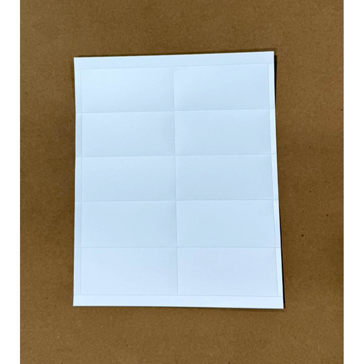 Durable, laser printable plastic card stock on perforated sheets for warehouse