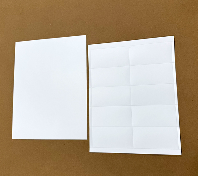 Durable, laser printable plastic card stock on perforated sheets for warehouse