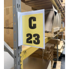 Magnetic warehouse aisle pouch sign on rack upright