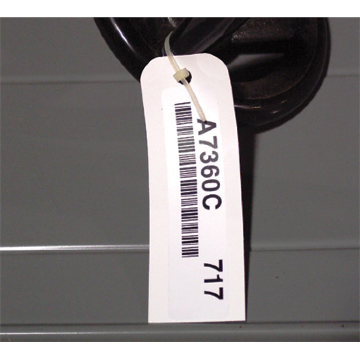 Warehouse label mount tag with a bar code label
